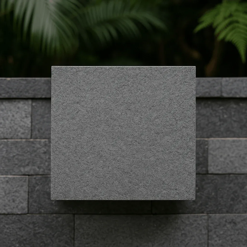 Grey andesite stone tile against an andesite wall