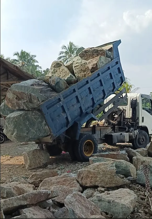 Truck unloading raw natural stone blocks