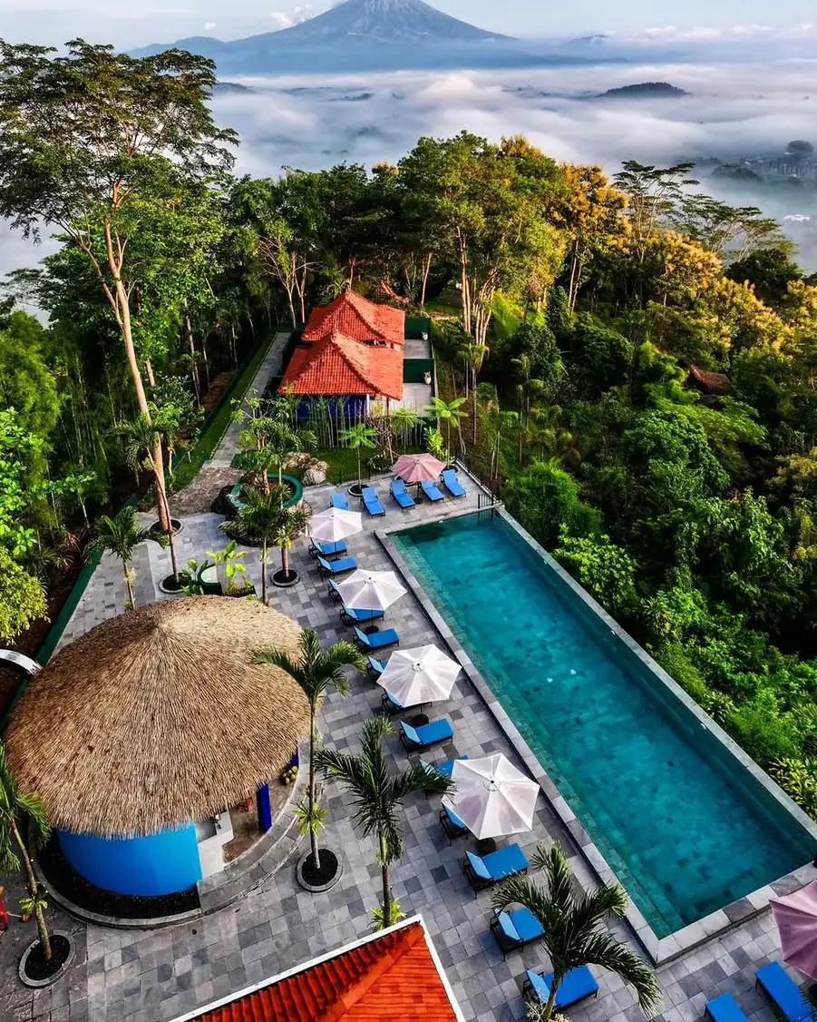 Aerial view of a resort swimming pool with tiled paving